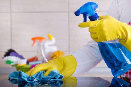 Professional home cleaners working in a SW11 apartment living room
