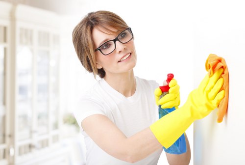 Professional cleaner beginning a thorough cleaning service in SW11